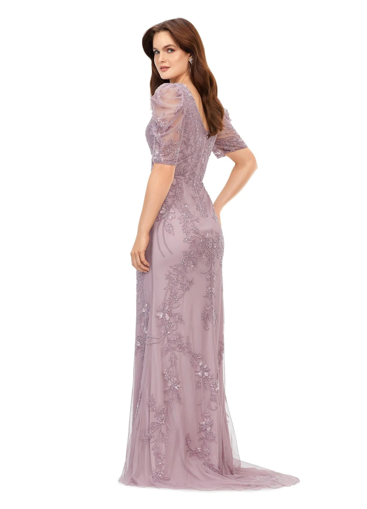 Back view of an elegant evening gown features a delicate floral lace design with subtle embroidery, puff sleeves, and a flattering V-neckline. The form-fitting silhouette flows into a soft train, exuding timeless sophistication.