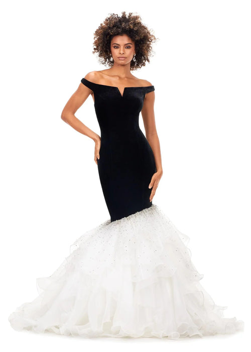 Regan Gown | Black-Ivory a stunning off-the-shoulder mermaid gown crafted from luxurious velvet, featuring a plunging sweetheart neckline and transitioning into a voluminous organza skirt adorned with shimmering embellishments for an elegant black-and-white contrast.