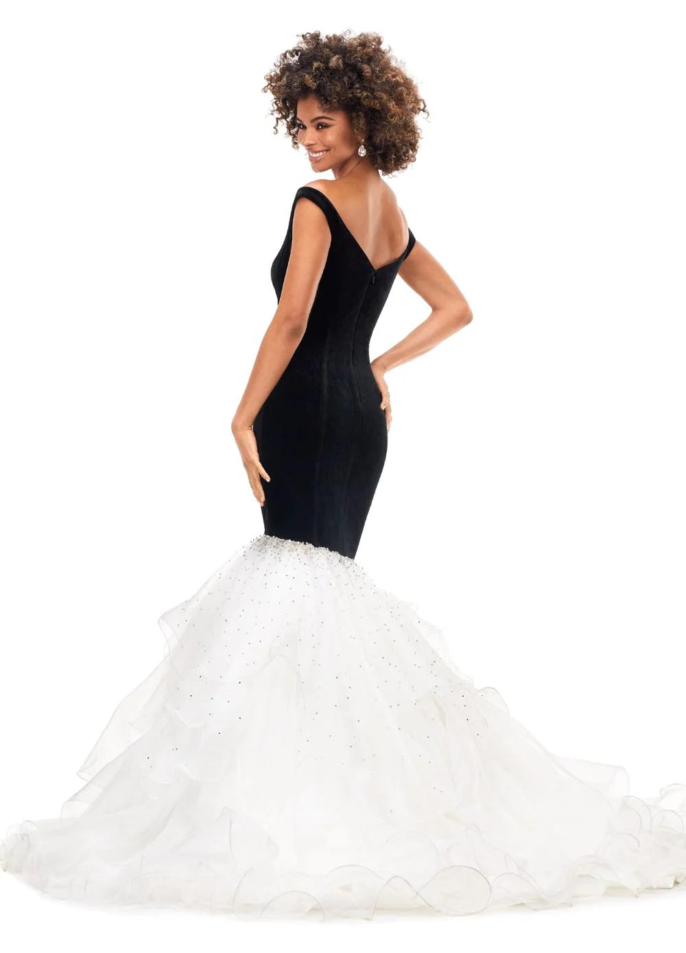 Back view of a stunning off-the-shoulder mermaid gown crafted from luxurious velvet, featuring a plunging sweetheart neckline and transitioning into a voluminous organza skirt adorned with shimmering embellishments for an elegant black-and-white contrast.