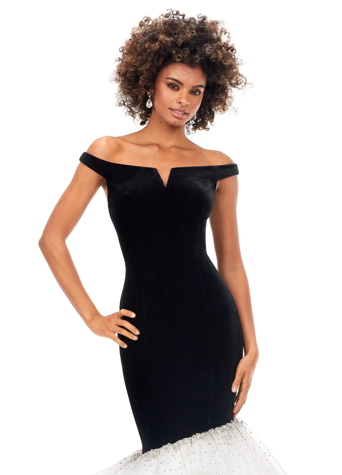 Close up of a stunning off-the-shoulder mermaid gown crafted from luxurious velvet, featuring a plunging sweetheart neckline and transitioning into a voluminous organza skirt adorned with shimmering embellishments for an elegant black-and-white contrast.