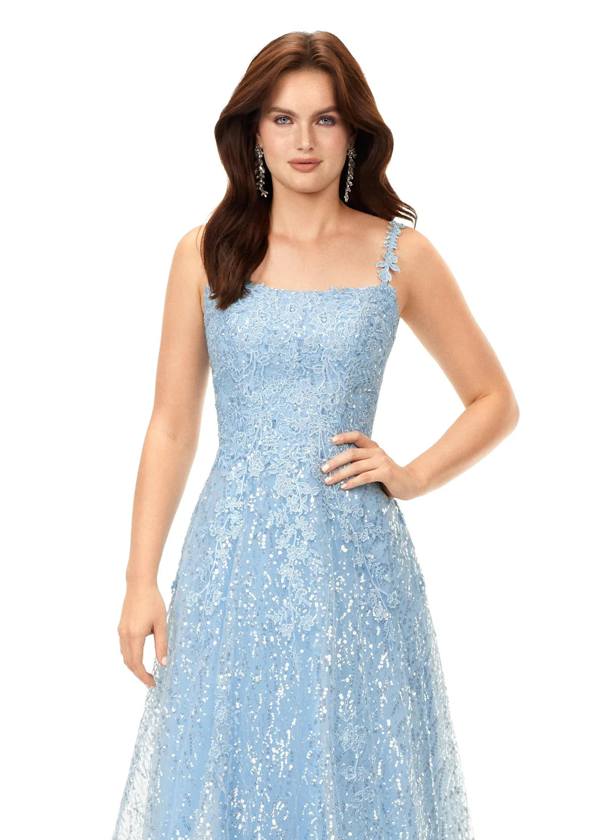 A light blue A-line gown adorned with delicate floral lace and shimmering sequins, featuring a square neckline and a softly flowing silhouette, perfect for a timeless and elegant look.