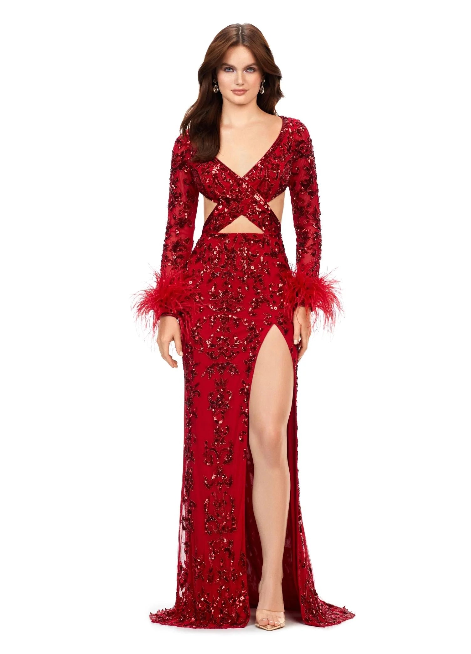 Red gown featuring intricate embroidery, long sheer sleeves, feathered cuffs, a daring cutout waistline, and a high slit for a chic and elegant look.