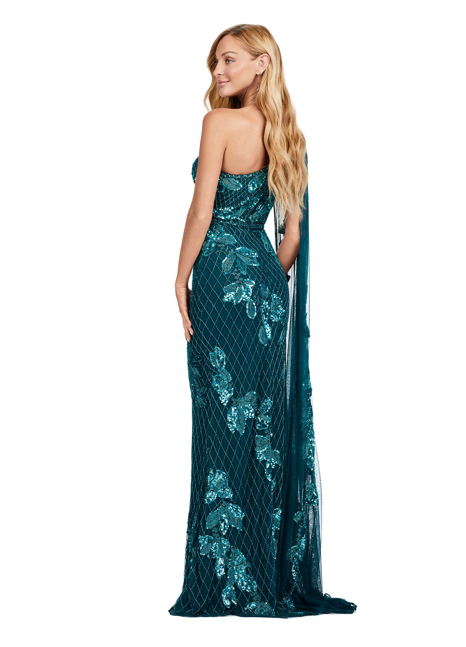 Back View - One-shoulder teal gown adorned with intricate floral sequin embroidery, a fitted silhouette, a dramatic floor-length cape detail, and a patterned design.