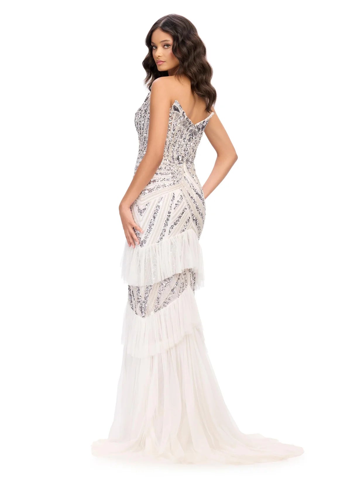White Strapless gown adorned with intricate beading and embroidery, featuring a plunging neckline and tiered tulle skirt with a thigh-high slit for added drama and allure.