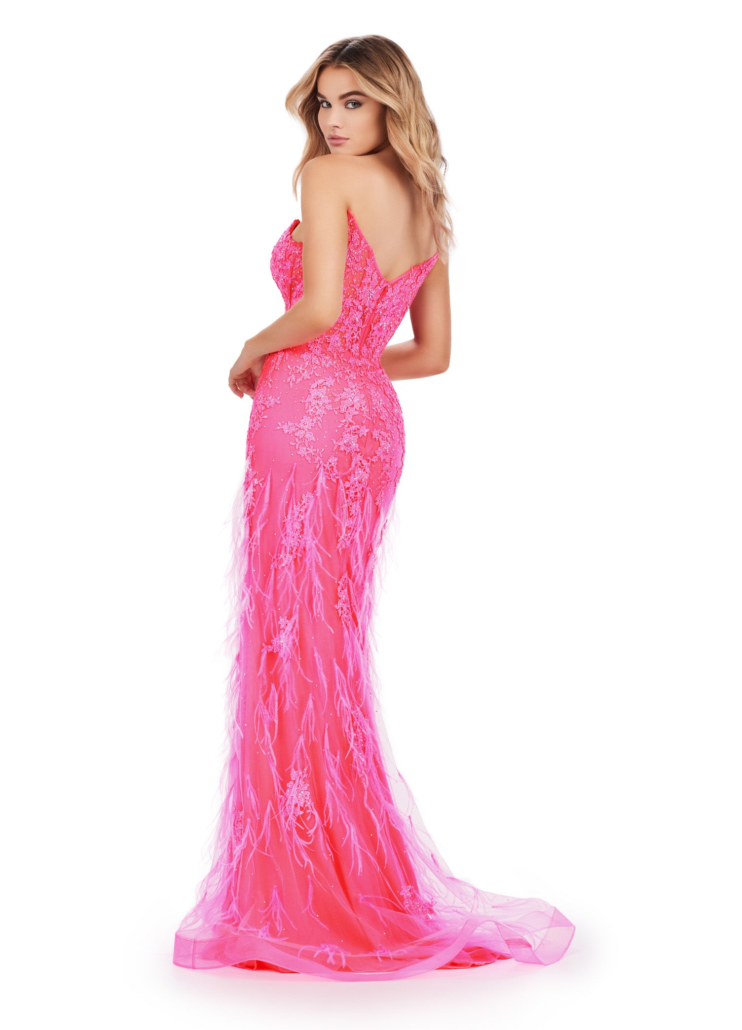 Elegant strapless pink gown with a deep plunging neckline, featuring intricate beading and feather embellishments, flowing into a fitted silhouette and delicate tulle skirt.