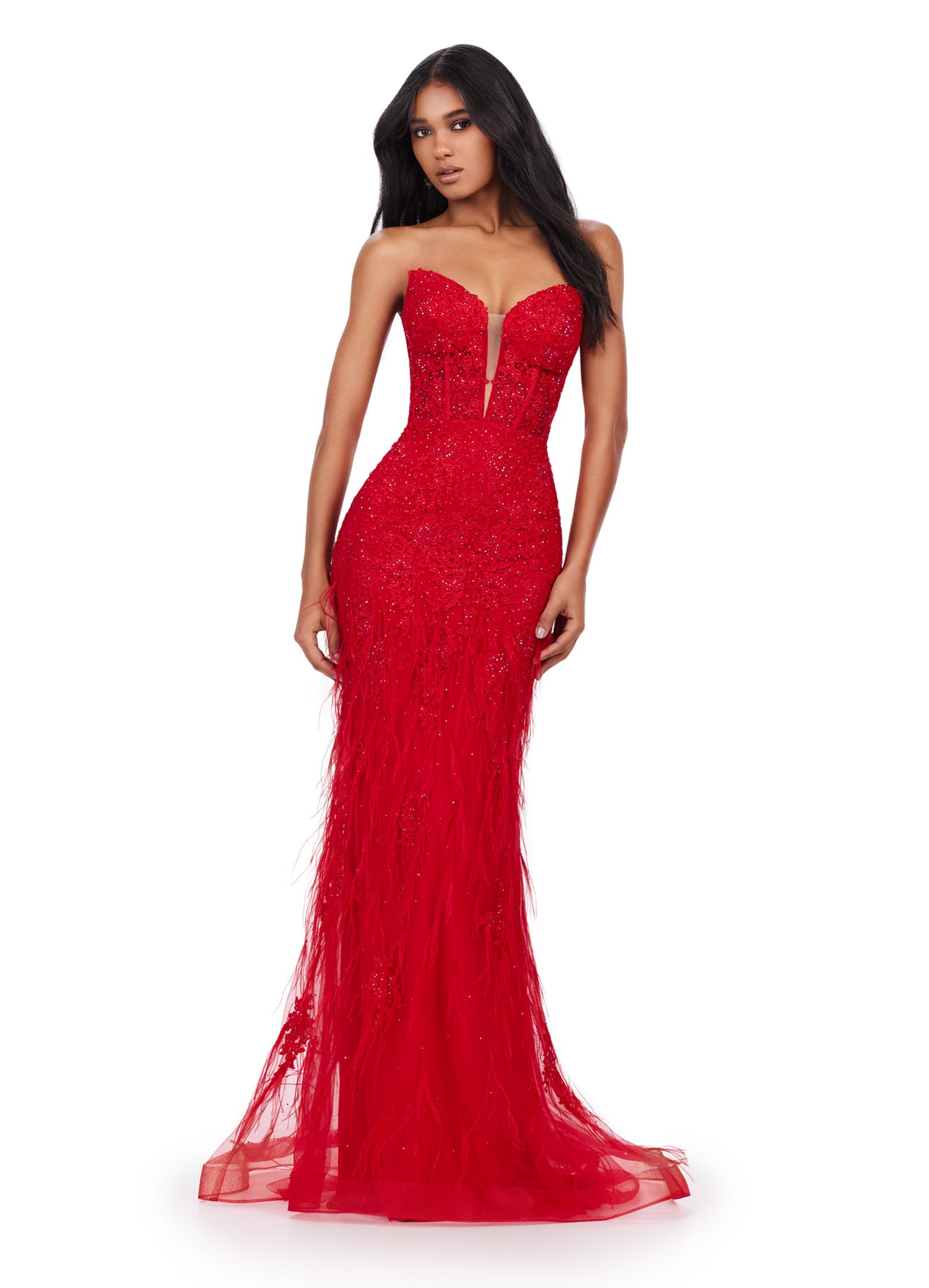 Elegant strapless red gown with a deep plunging neckline, featuring intricate beading and feather embellishments, flowing into a fitted silhouette and delicate tulle skirt.