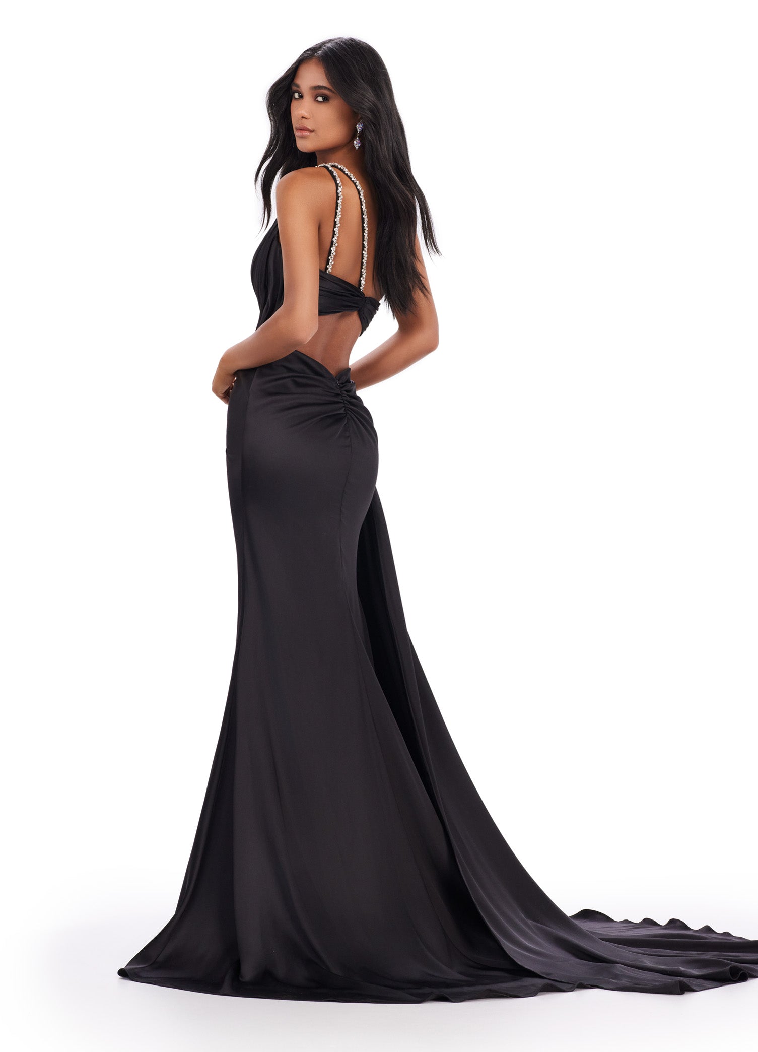 Back view - Elegant black floor-length gown featuring a one-shoulder design, draped bodice with sparkling embellishments, a thigh-high slit, and a flowing train for a sophisticated and glamorous look.
