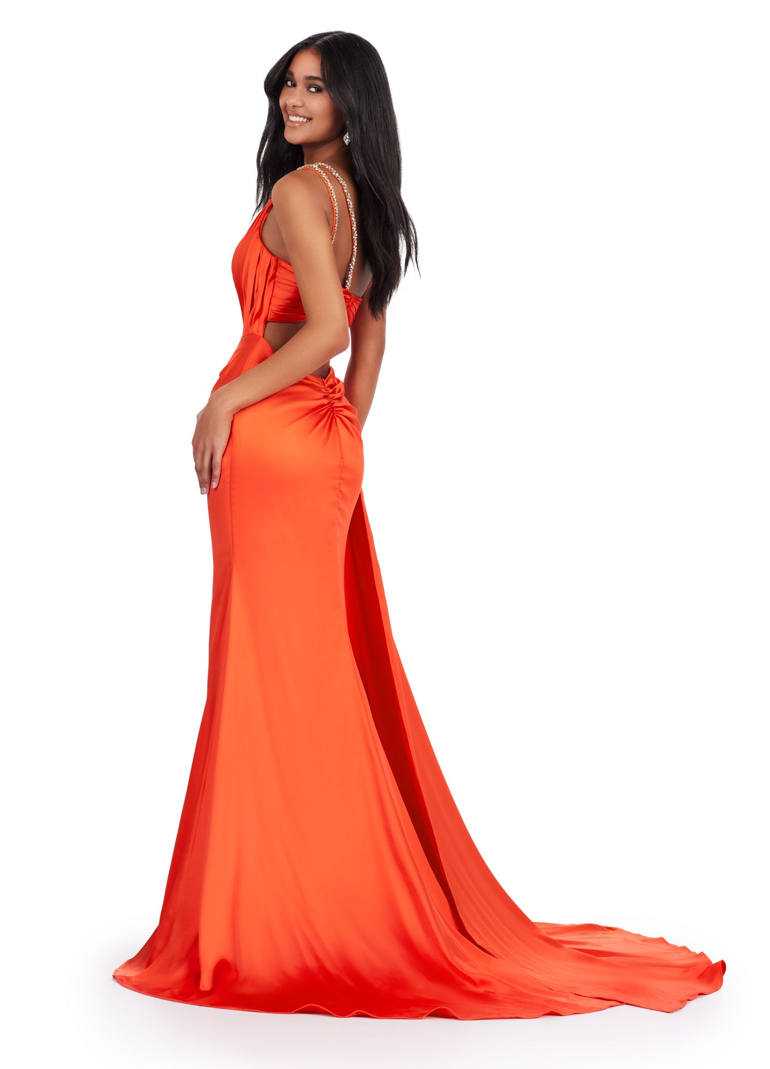 Back view - Elegant orange floor-length gown featuring a one-shoulder design, draped bodice with sparkling embellishments, a thigh-high slit, and a flowing train for a sophisticated and glamorous look.