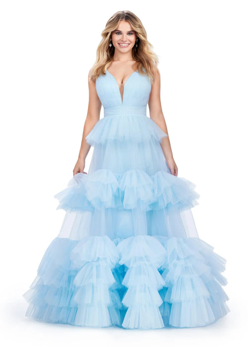 Romola Gown | Sky A stunning ball gown featuring a fitted V-neckline bustier and a deep V-back for an elegant, structured silhouette. The multi-tiered tulle ruffle skirt cascades gracefully, creating a voluminous and ethereal look. Perfect for galas, pageants, and special occasions, this gown exudes romance and sophistication.
