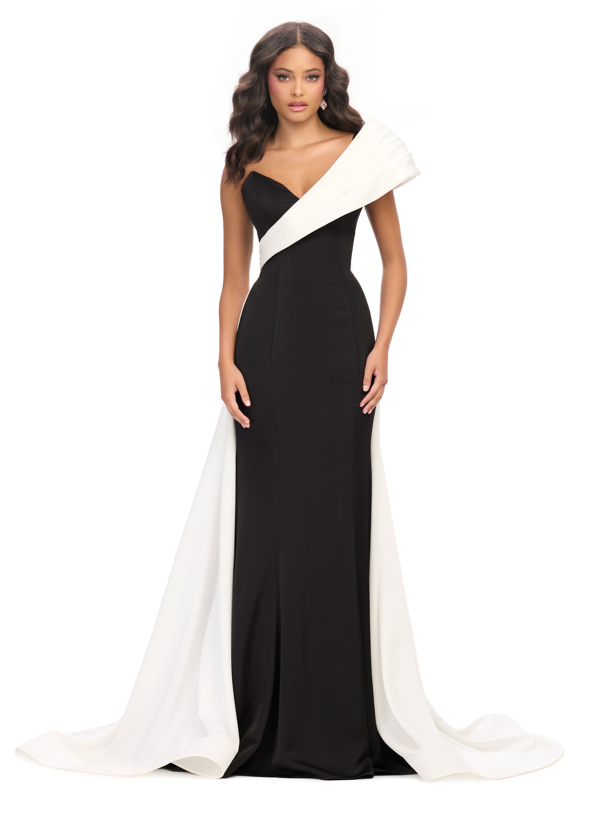Black gown with an asymmetrical neckline, fitted silhouette, and dramatic white off-the-shoulder draping that extends into a floor-length train.