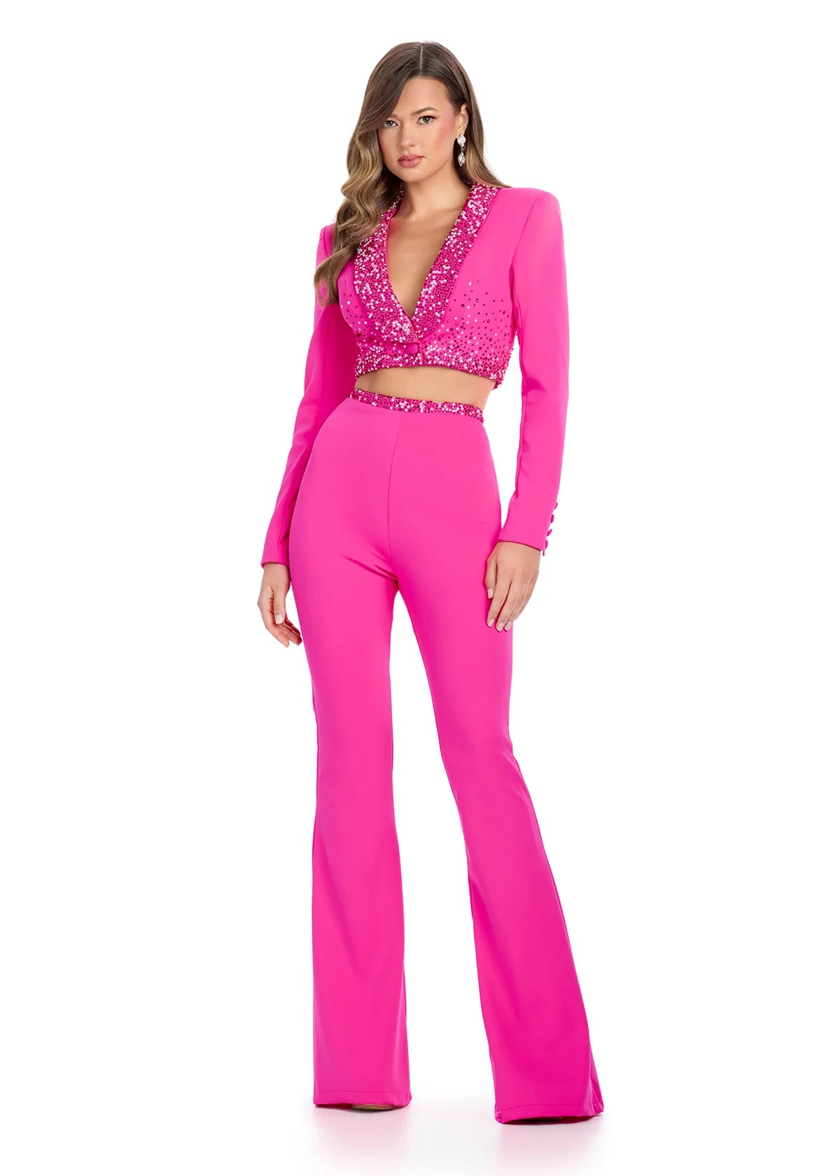 Fuchsia tailored two-piece outfit featuring a cropped jacket with a deep V-neckline embellished with navy beading and matching high-waisted flared trousers.