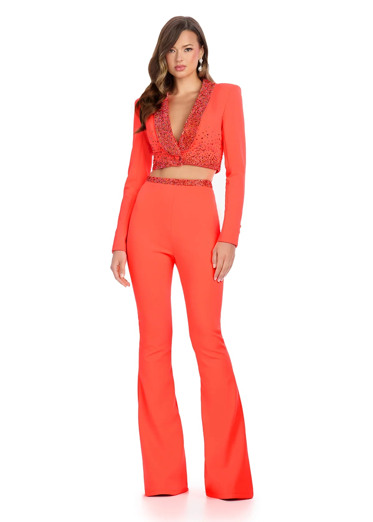 Coral tailored two-piece outfit featuring a cropped jacket with a deep V-neckline embellished with navy beading and matching high-waisted flared trousers.