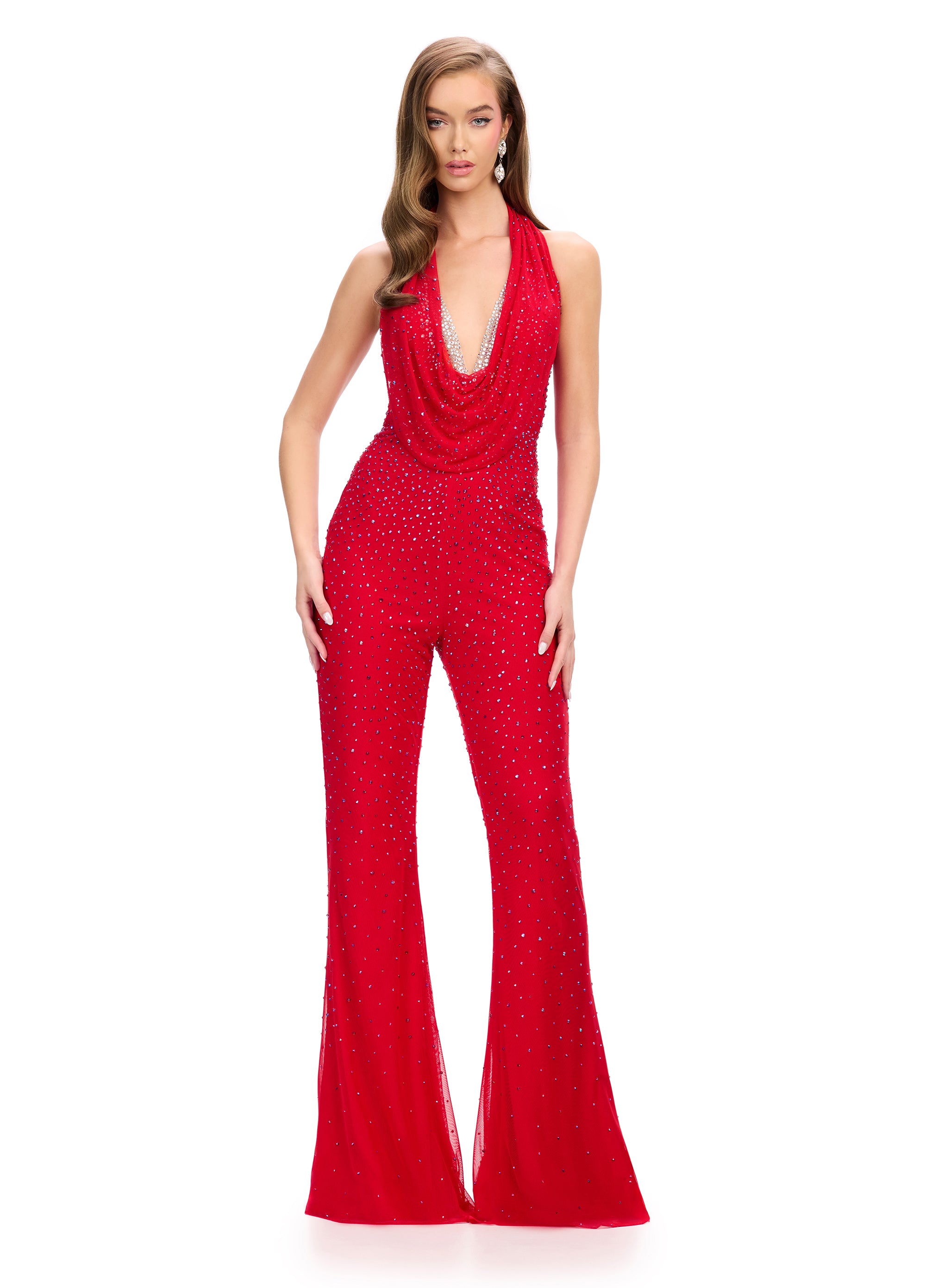 Show-stopping red halter jumpsuit adorned with shimmering embellishments, featuring a dramatic draped neckline and flared trousers for a glamorous, retro-inspired look.