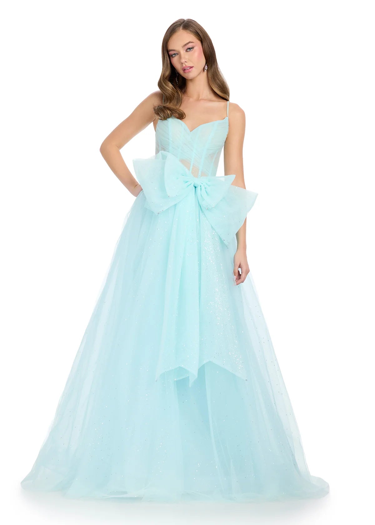 Sky blue tulle ball gown with delicate spaghetti straps, a sheer corset bodice, and an oversized bow accent for a fairytale-inspired look.