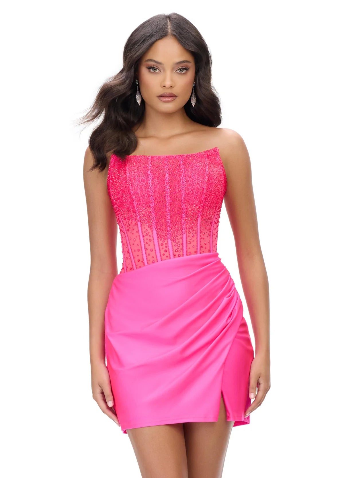 Pink strapless cocktail dress with a beaded bodice and sheer detailing, paired with a draped mini skirt featuring a side slit for an elegant evening look.