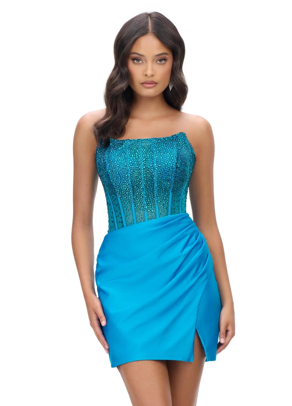 Turquoise strapless cocktail dress with a beaded bodice and sheer detailing, paired with a draped mini skirt featuring a side slit for an elegant evening look.