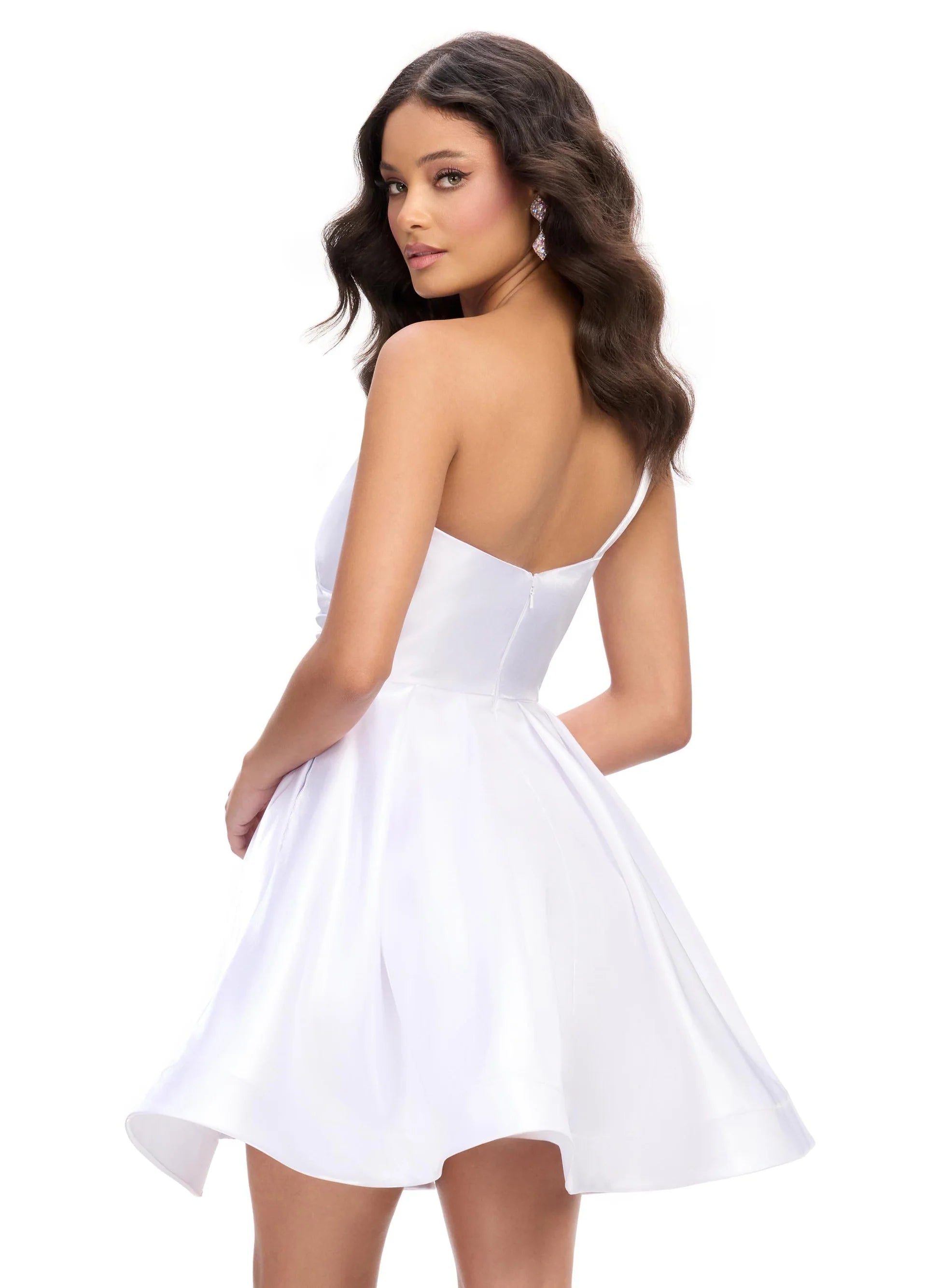 White satin mini dress featuring an asymmetrical neckline, a fitted bodice with subtle pleating, and a flared skirt for a chic and playful look. Back View.