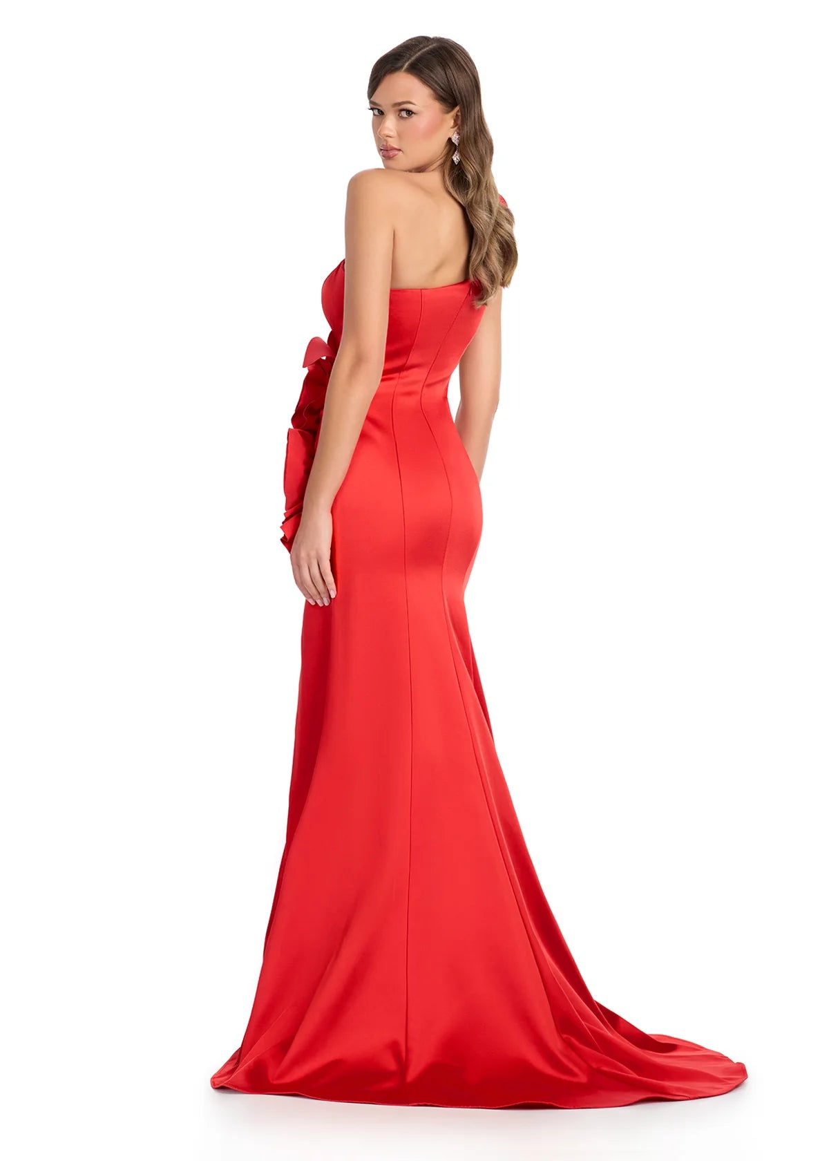 Back View - Red gown with an asymmetrical neckline, large rose accents, side cut-out, high slit, and a floor-length fitted silhouette.