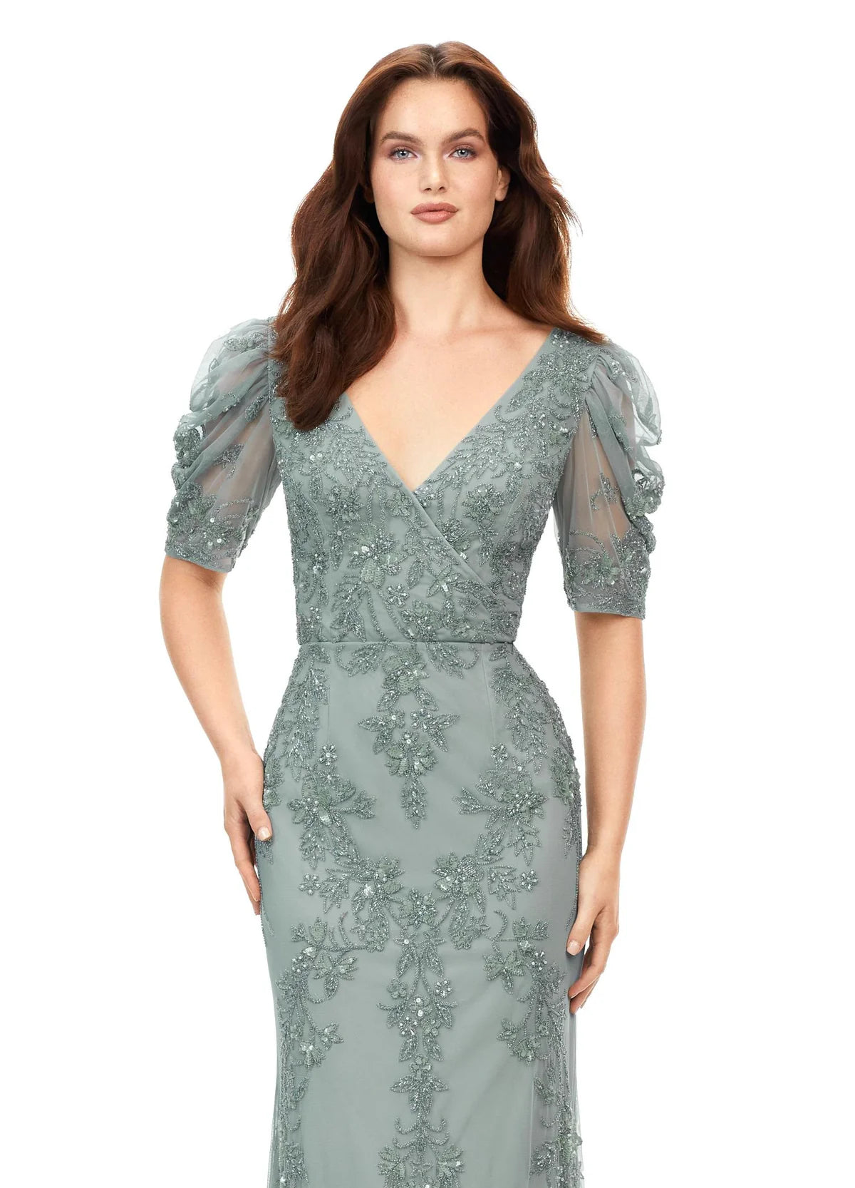 Close up of an elegant gown with floral embroidery, sheer detailing, ruched puff sleeves, and a modest scoop back