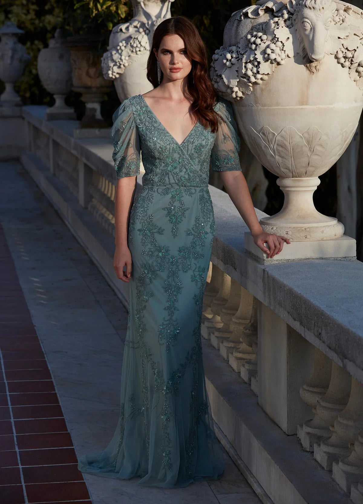 Sage green gown with floral embroidery, sheer detailing, ruched puff sleeves, and a modest scoop back