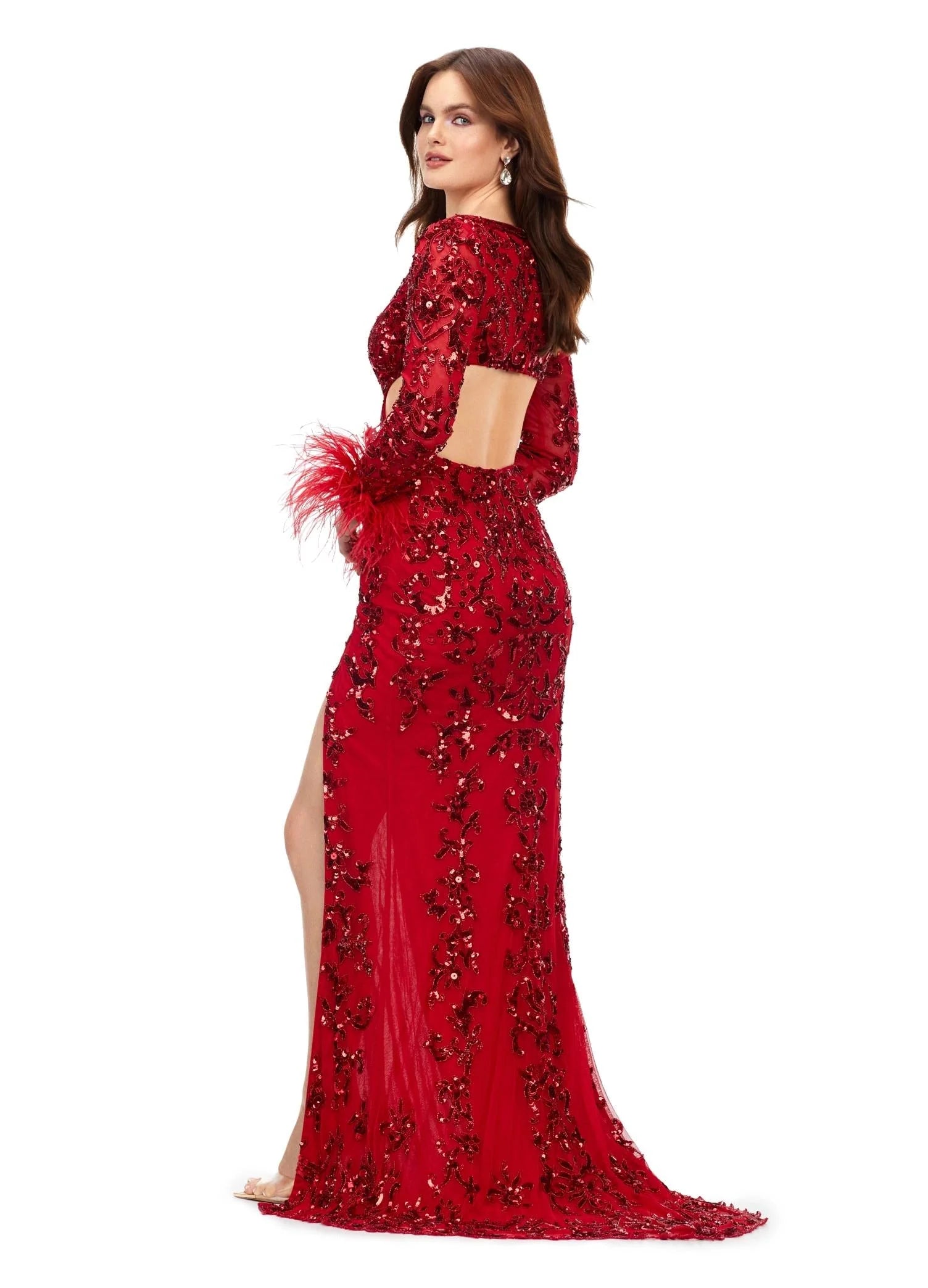 Back view - Red gown featuring intricate embroidery, long sheer sleeves, feathered cuffs, a daring cutout waistline, and a high slit for a chic and elegant look.