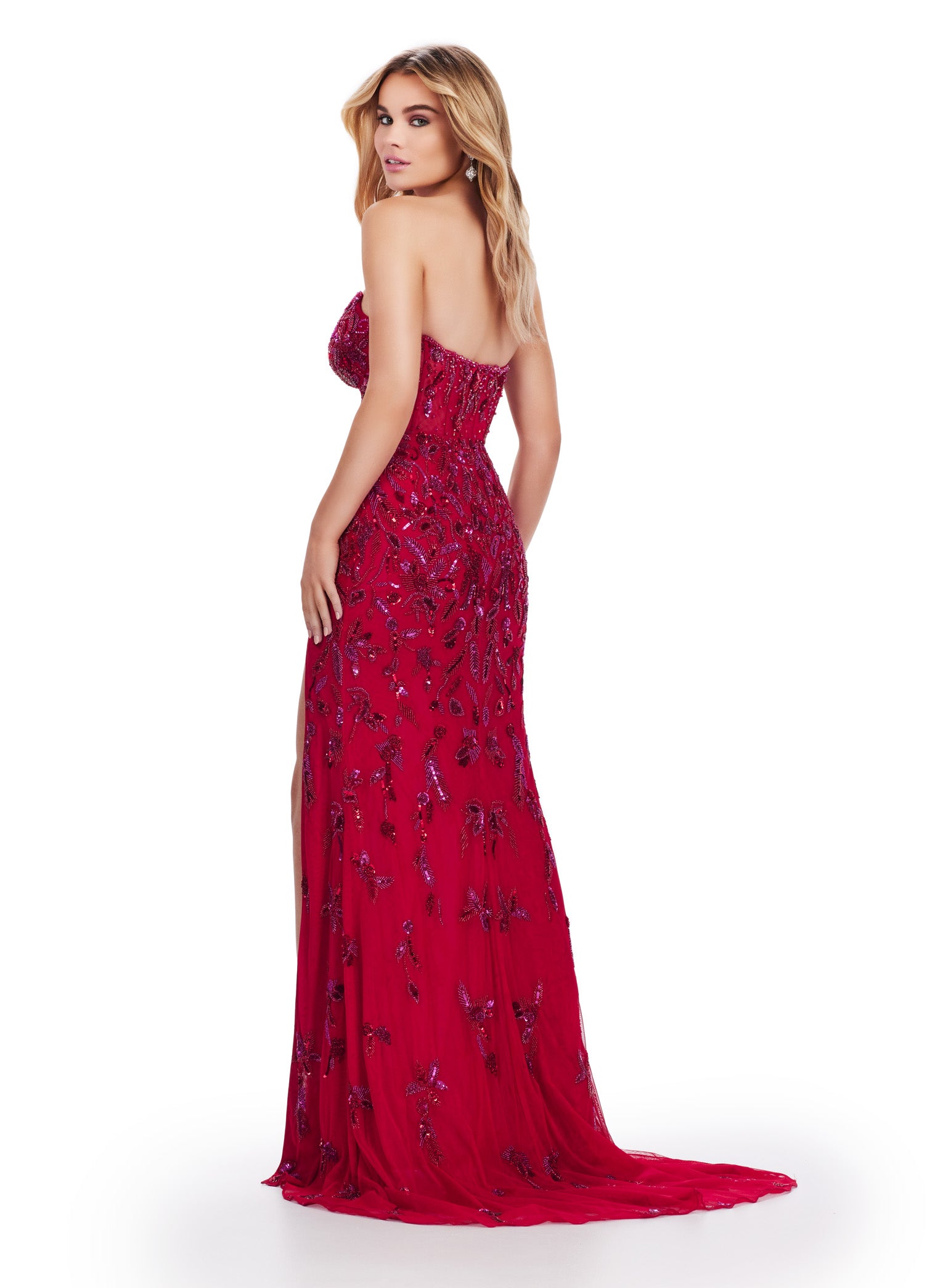 Back view of a stunning red strapless gown adorned with intricate beaded embellishments, featuring a fitted bodice, a thigh-high slit, and a sheer overlay for a captivating and glamorous look.