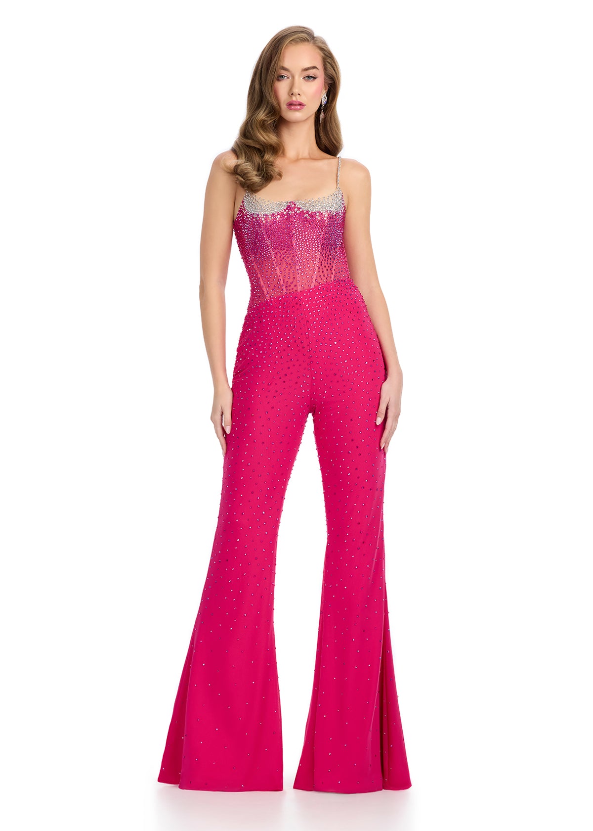 Vibrant fuchsia embellished jumpsuit featuring a sheer corset-style bodice, delicate straps, and flared trousers adorned with sparkling rhinestones for a bold, glamorous statement.