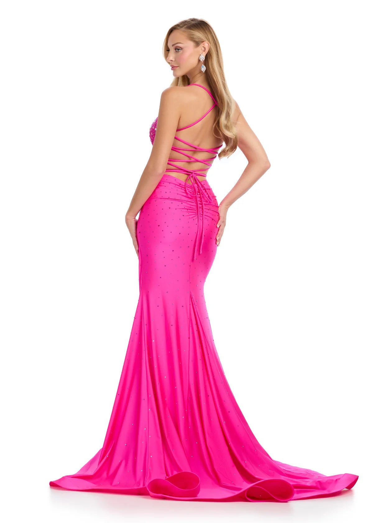 Back View - Hot pink evening gown featuring a fitted silhouette, a plunging neckline embellished with sparkling accents, and delicate straps for an elegant and glamorous look.