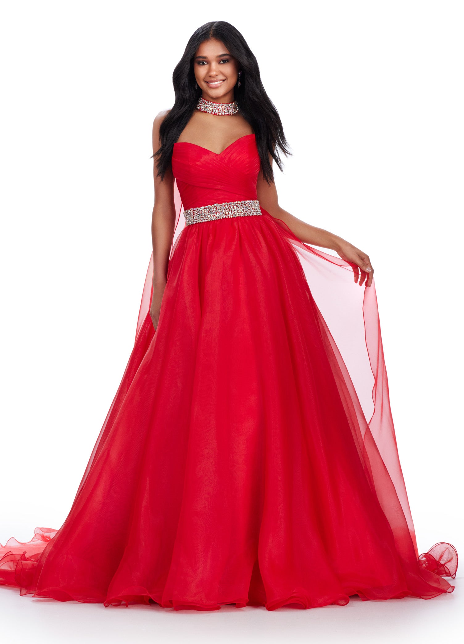 Red ball gown featuring a sweetheart neckline, ruched bodice, sparkling embellished waistband, and a flowing tulle skirt for a fairytale-inspired look.