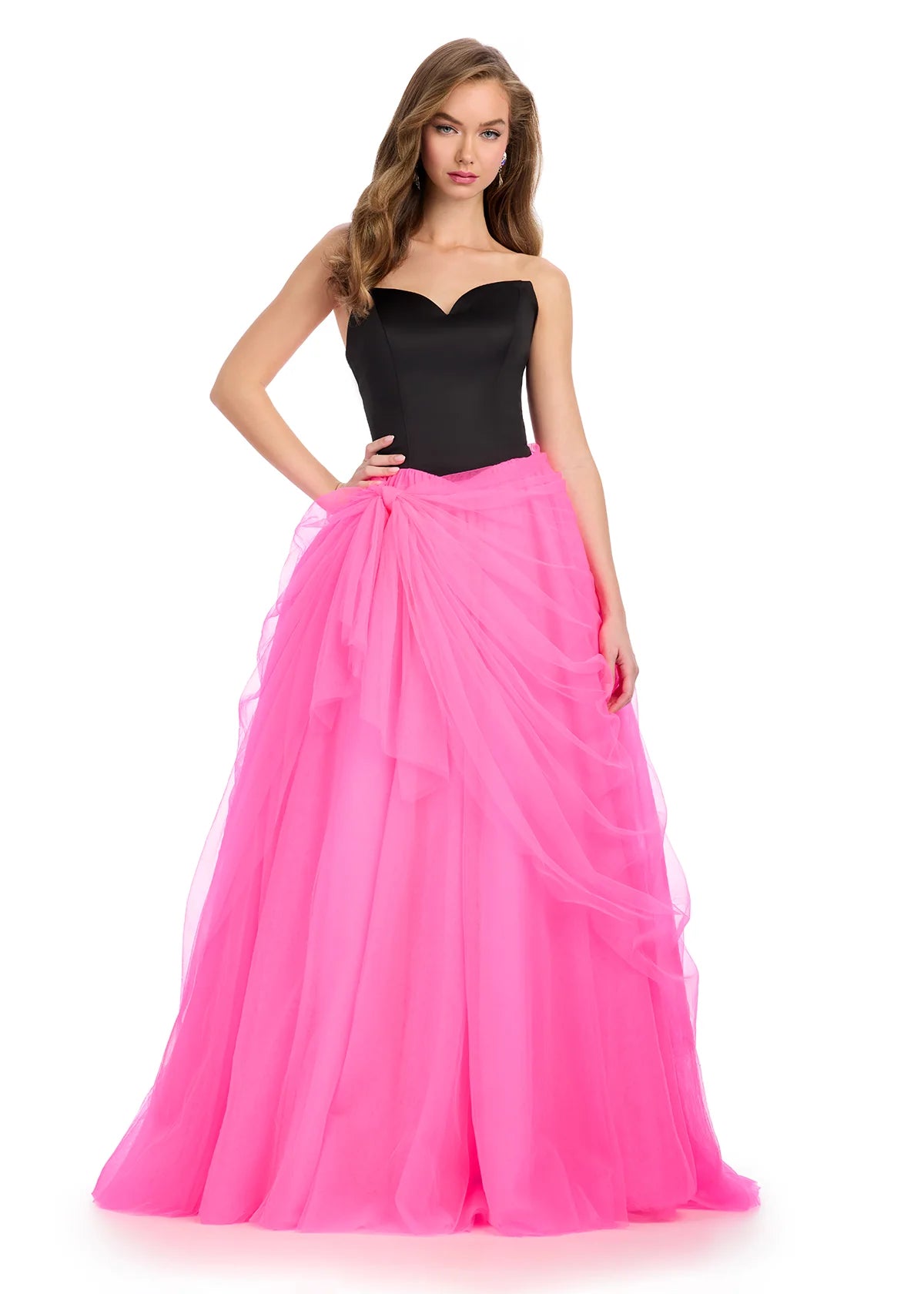 Video - Strapless gown with a fitted black bodice and a voluminous hot pink tulle skirt tied with a flowing bow detail.