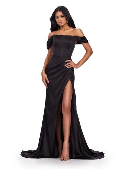 Video - Off-the-shoulder black evening gown featuring a corset-style bodice with pleated detailing, ruffled sleeve accents, a high leg slit, and a floor-length skirt with a slight train.