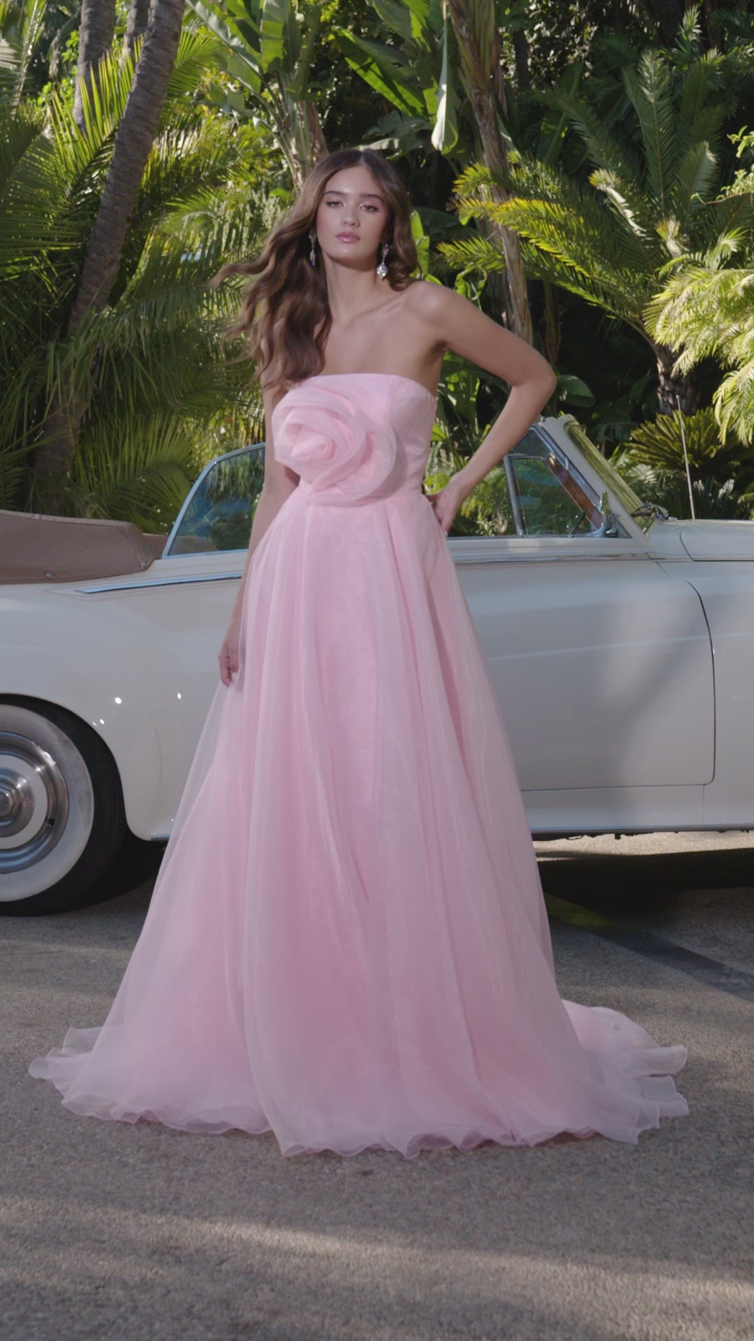 Video - Strapless light pink gown with a large rose detail on the bodice and a flowing A-line silhouette.